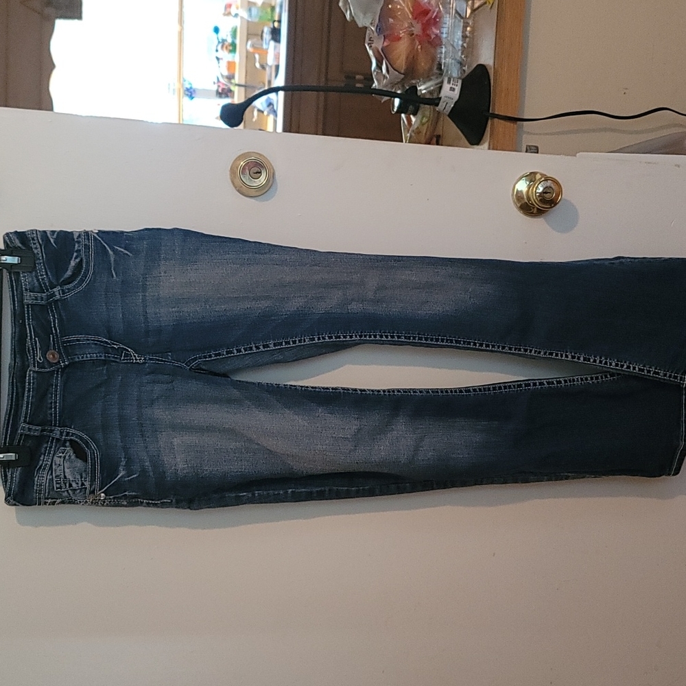 Junior jeans.  Faded look.  Pocket designs.  Boot cut